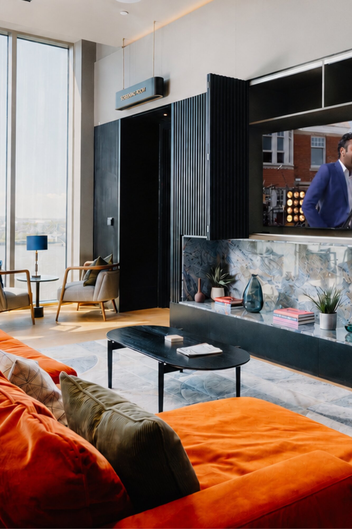 Sky lounge with a burnt-orange velvet sofa, armchairs and floor-to-ceiling windows