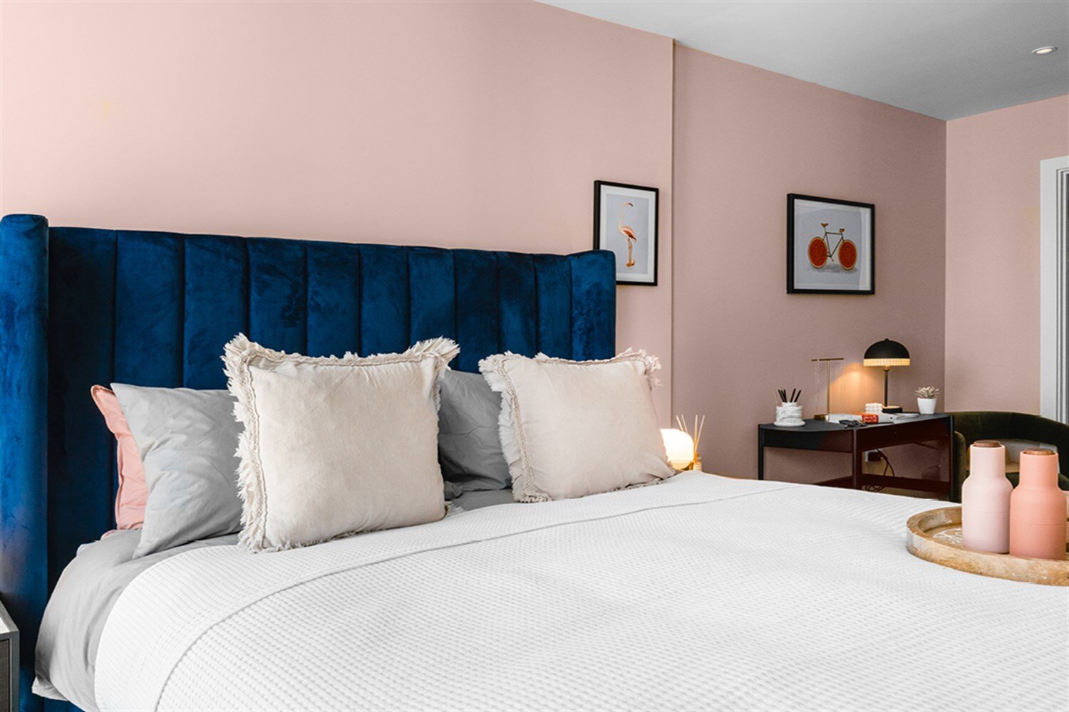 Bedroom with blush walls, a navy velvet headboard and a desk by the window, at The Mercian, Birmingham