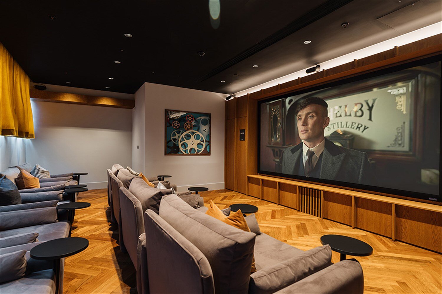 Residents' screening room with deep sofas facing a wide screen, at The Mercian, Birmingham