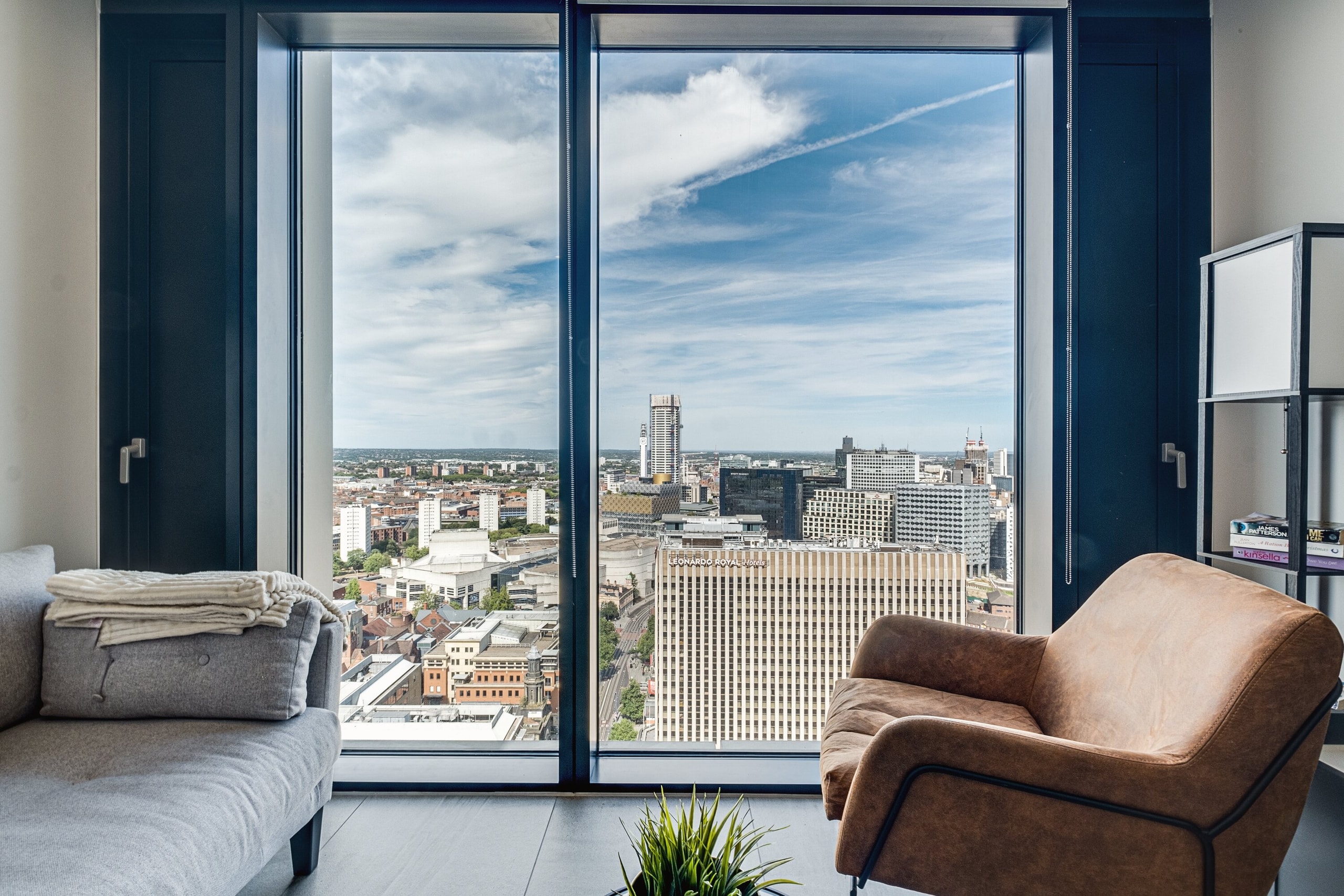 Corner living room with floor-to-ceiling windows looking out across the Birmingham skyline