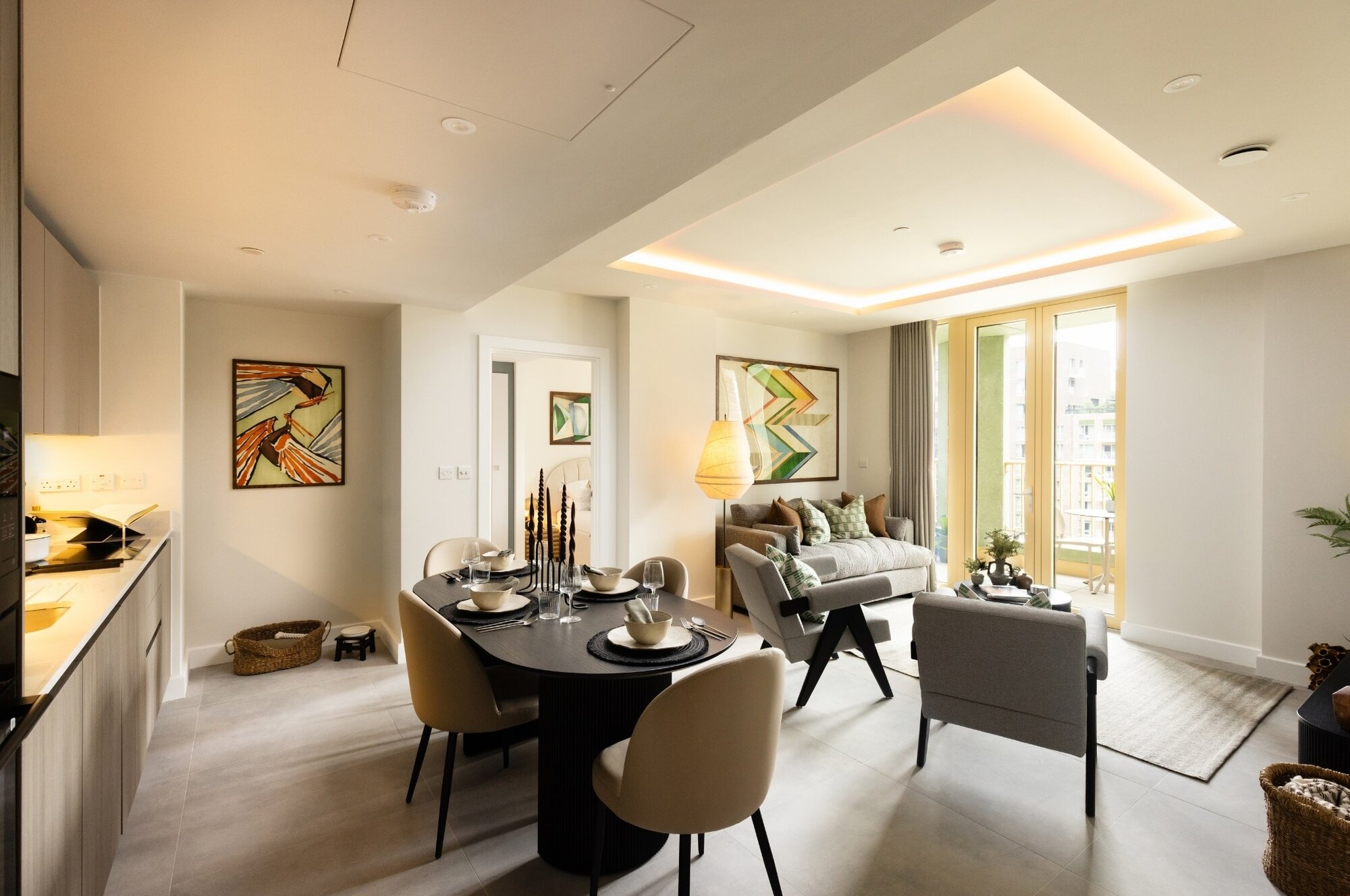 Open-plan kitchen, dining and living room beneath a lit ceiling coffer